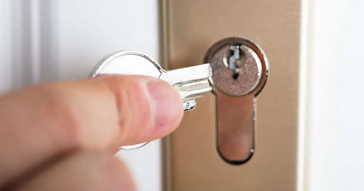 Locksmith removing a broken key from a door lock